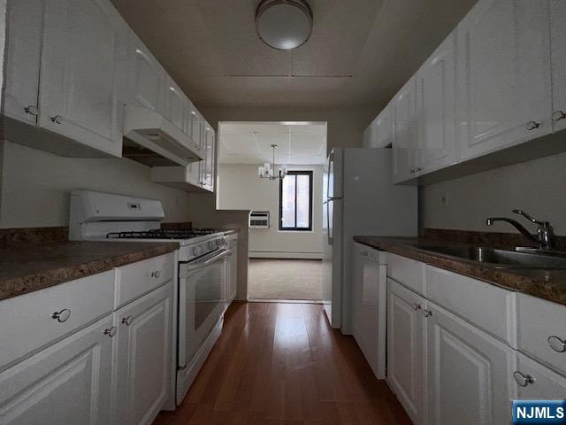 77 Prospect Avenue, Unit 1A Hackensack, NJ 07601 - Photo 6 of 16 a kitchen with stainless steel appliances granite countertop a sink dishwasher stove and white cabinets