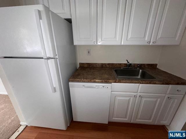 77 Prospect Avenue, Unit 1A Hackensack, NJ 07601 - Photo 7 of 16 a kitchen with granite countertop white cabinets and refrigerator