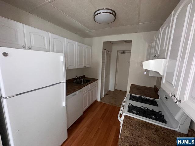 77 Prospect Avenue, Unit 1A Hackensack, NJ 07601 - Photo 8 of 16 a kitchen with sink refrigerator and stove