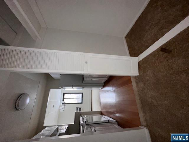 77 Prospect Avenue, Unit 1A Hackensack, NJ 07601 - Photo 9 of 16 wooden floor in an empty room with a window