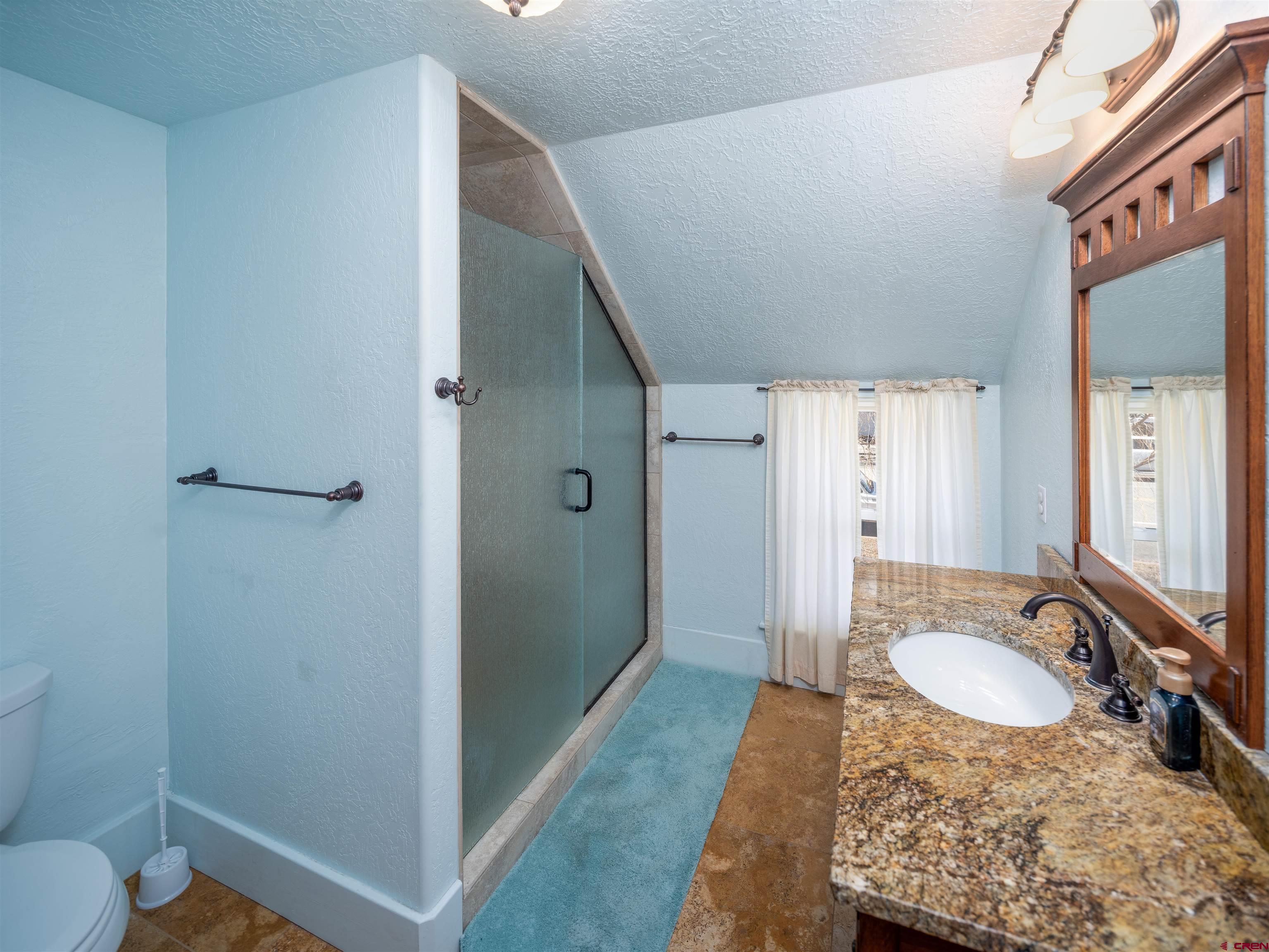 144 South Market Street Cortez, CO 81321 - Photo 20 of 41 a bathroom with a granite countertop sink and a mirror