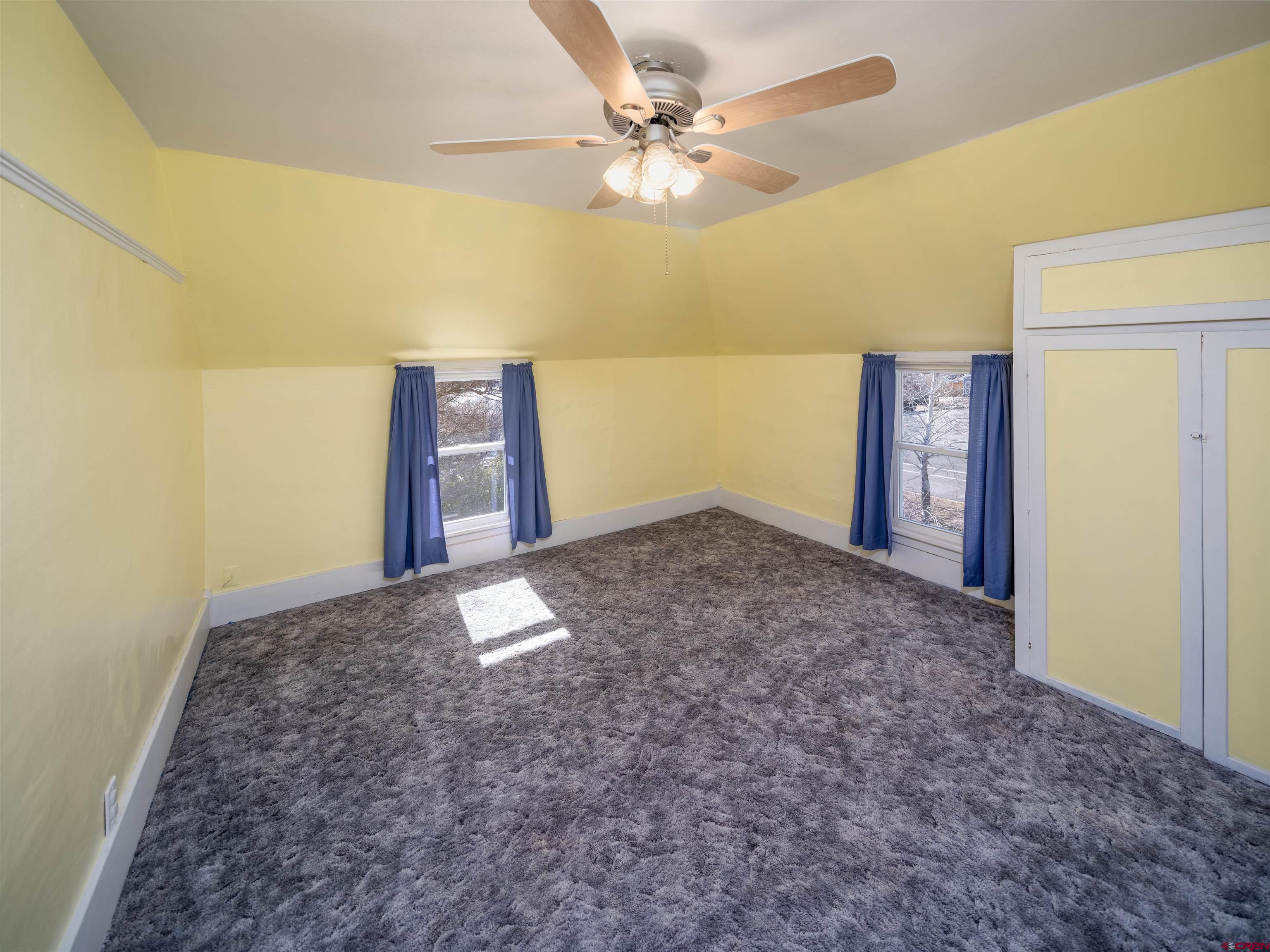 144 South Market Street Cortez, CO 81321 - Photo 22 of 41 a view of a big room with closet and ceiling fan
