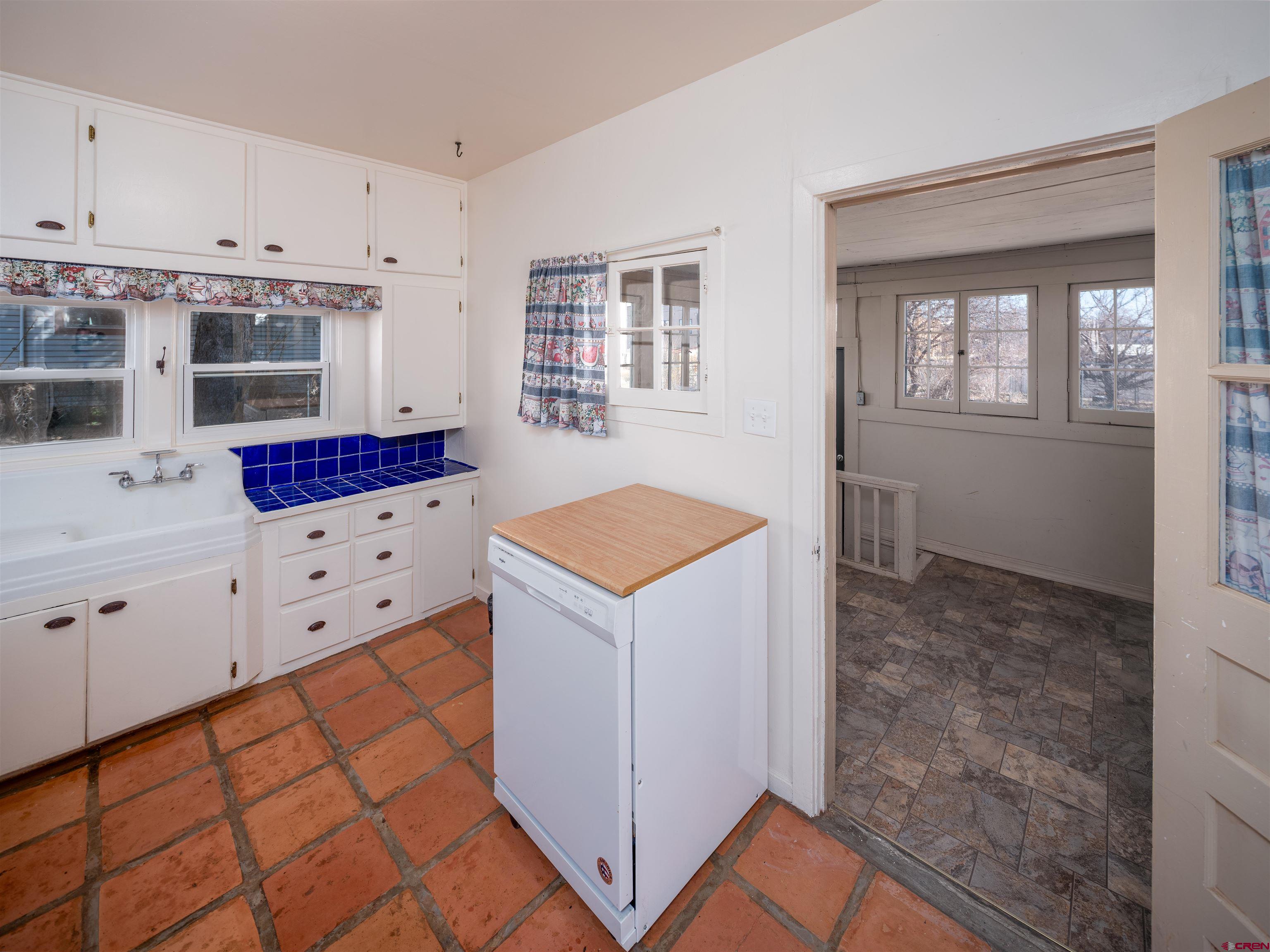 144 South Market Street Cortez, CO 81321 - Photo 6 of 41 a kitchen with white cabinets and white appliances