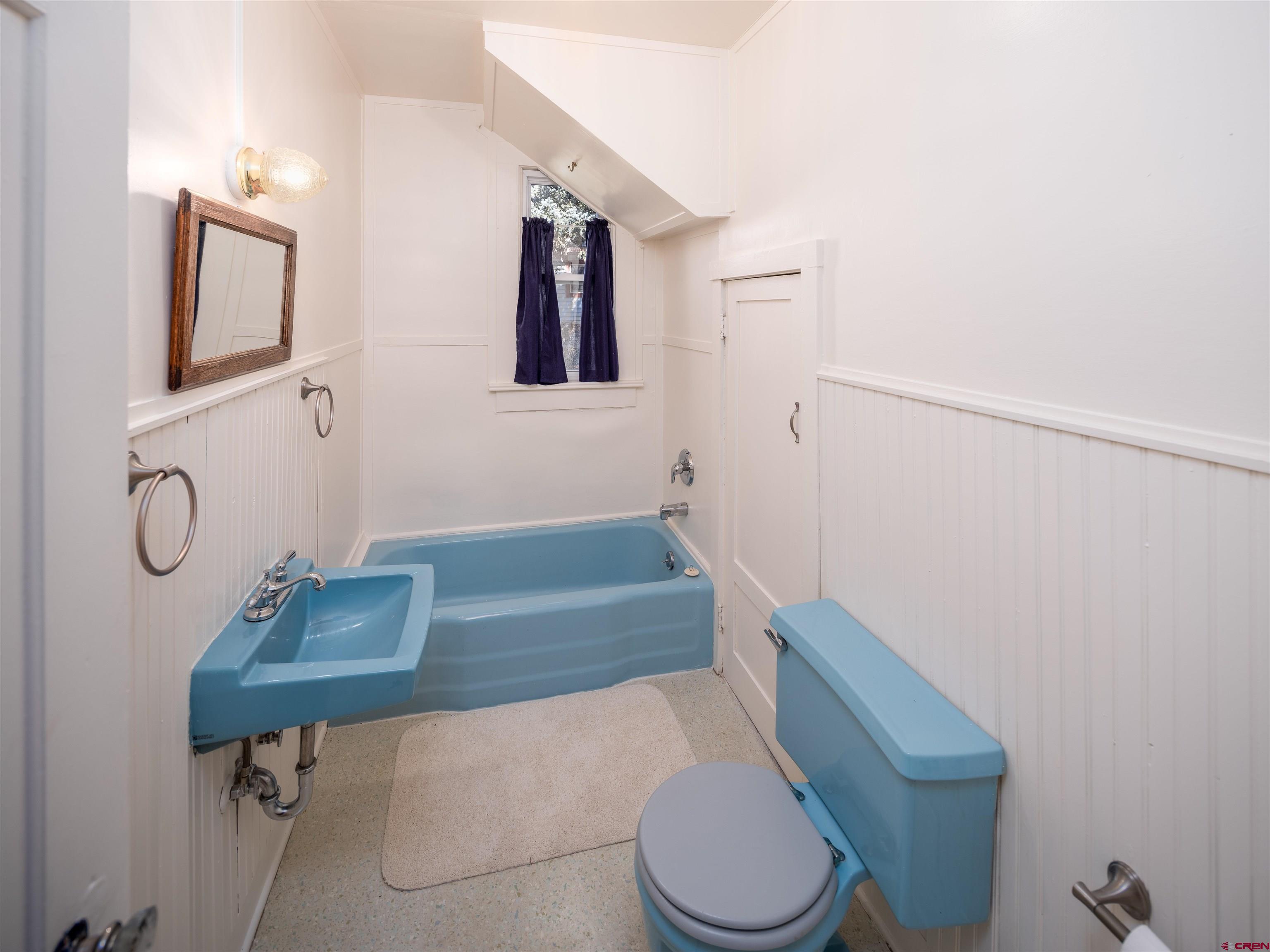 144 South Market Street Cortez, CO 81321 - Photo 10 of 41 a bathroom with a toilet sink and mirror