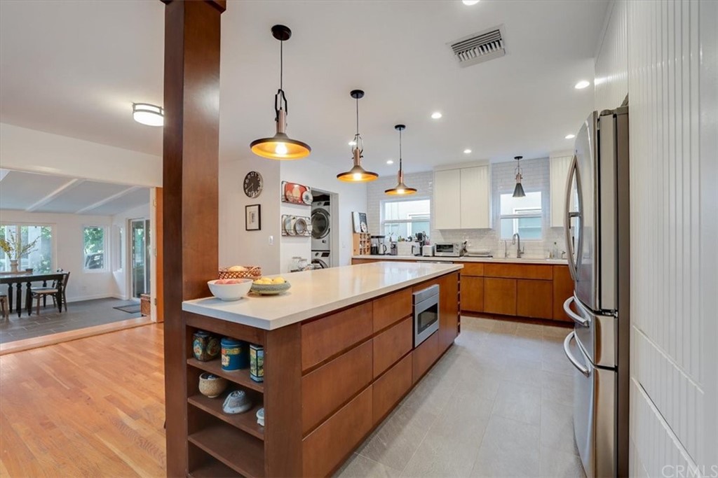13040 Delano Street Van Nuys, CA 91401 - Photo 11 of 64 a kitchen with stainless steel appliances granite countertop a sink stove and a refrigerator