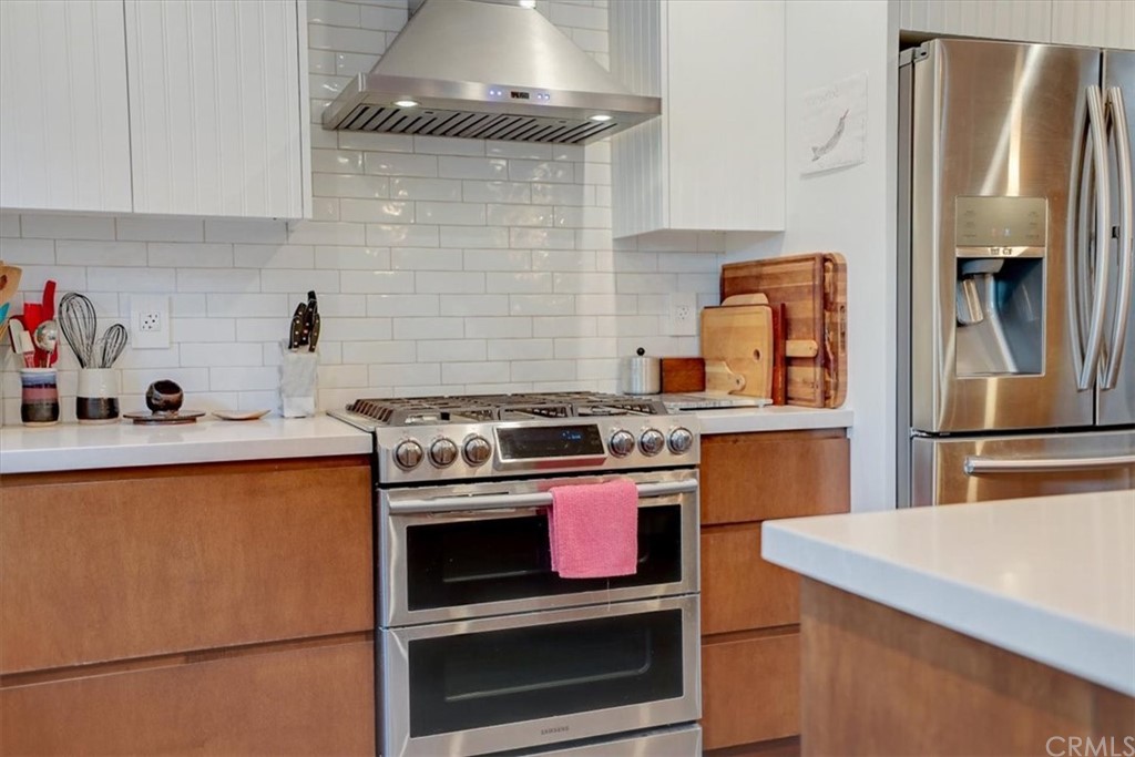 13040 Delano Street Van Nuys, CA 91401 - Photo 14 of 64 a kitchen with stainless steel appliances granite countertop a sink stove and refrigerator