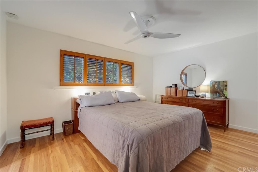 13040 Delano Street Van Nuys, CA 91401 - Photo 18 of 64 a bedroom with a bed and a dresser with wooden floor