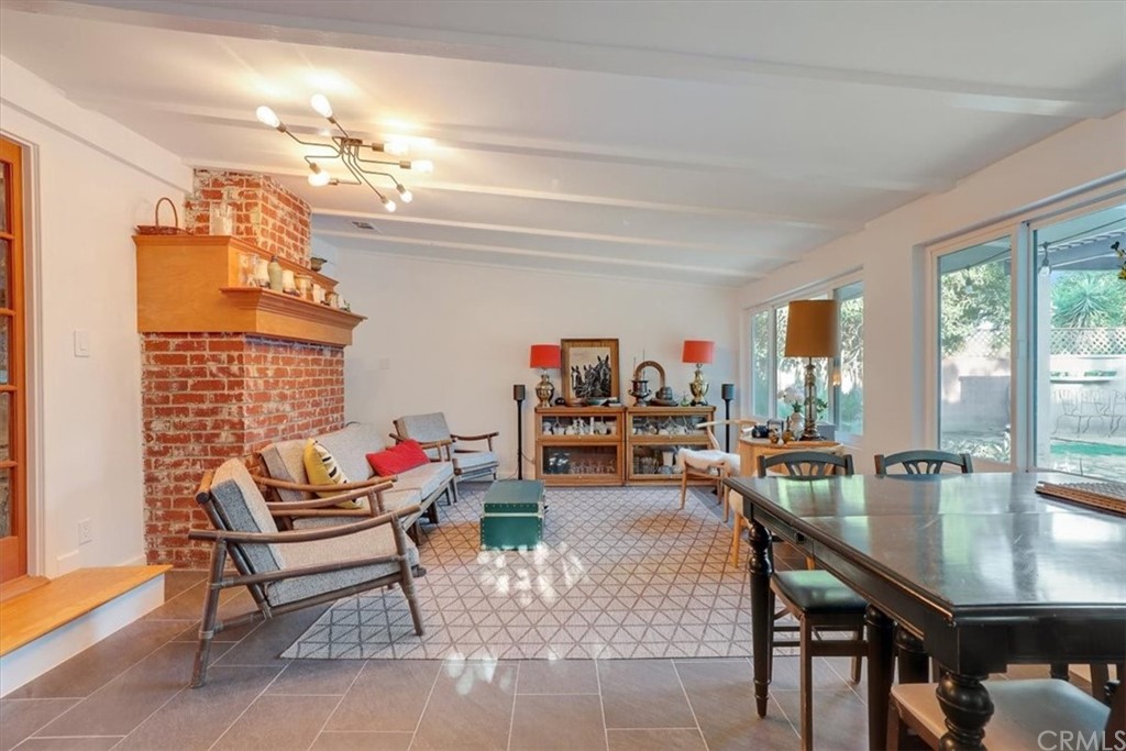 13040 Delano Street Van Nuys, CA 91401 - Photo 28 of 64 a living room with furniture and a dining table