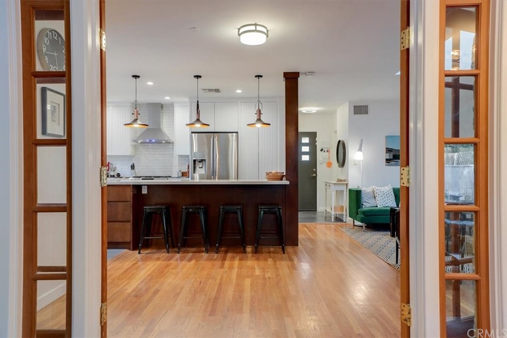 13040 Delano Street Van Nuys, CA 91401 - Photo 29 of 64 a kitchen with stainless steel appliances kitchen island granite countertop a refrigerator and a sink