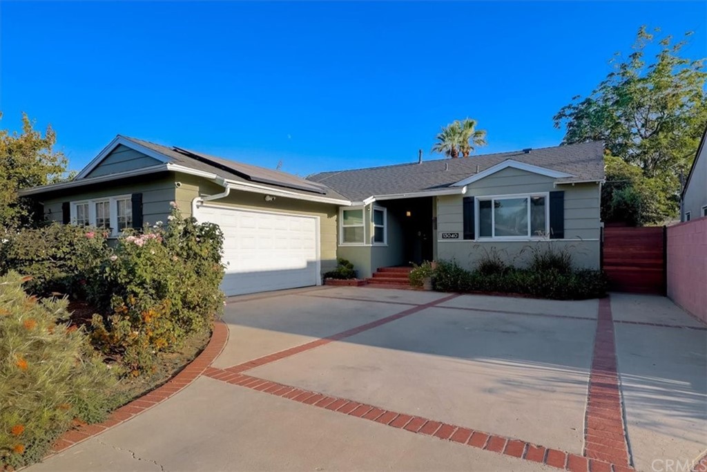 13040 Delano Street Van Nuys, CA 91401 - Photo 3 of 64 a front view of a house with a yard