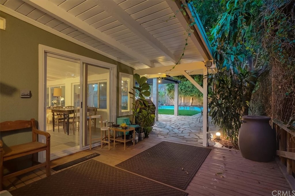 13040 Delano Street Van Nuys, CA 91401 - Photo 44 of 64 a porch with a table and chairs and potted plants