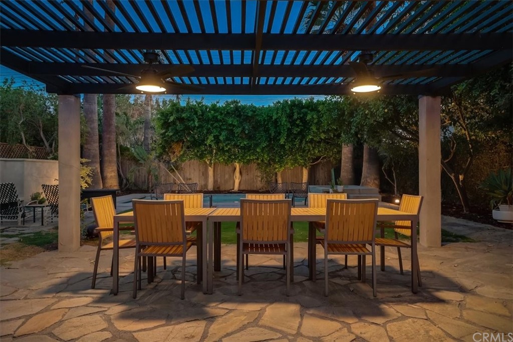 13040 Delano Street Van Nuys, CA 91401 - Photo 46 of 64 a view of a patio with table and chairs with wooden floor and fence