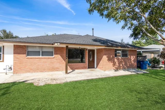 a view of a house with backyard porch and sitting area