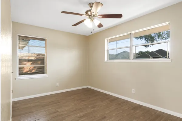 wooden floor in an empty room with a window