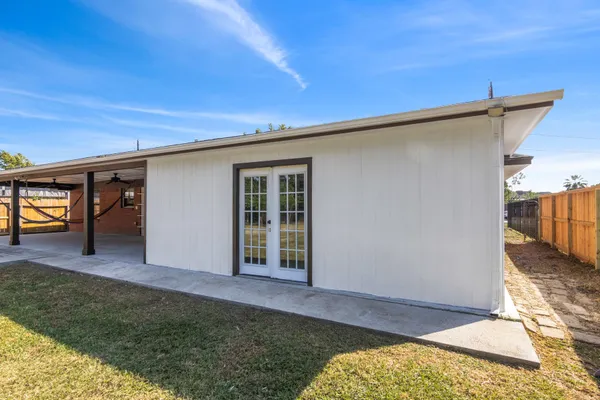 a view of an house with backyard porch and entertaining space