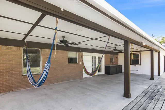 a view of a room with wooden floor and windows