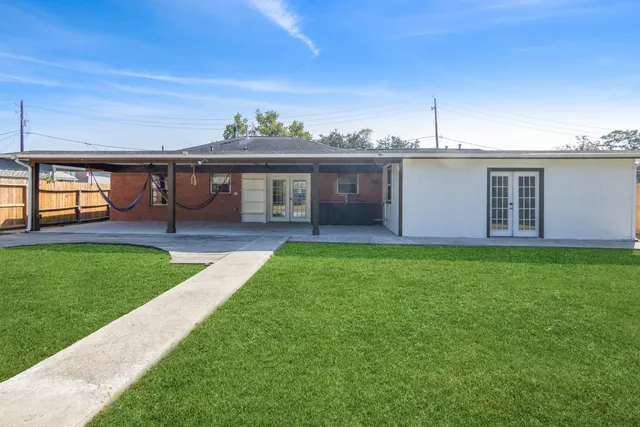 a view of a house with a backyard and a garden