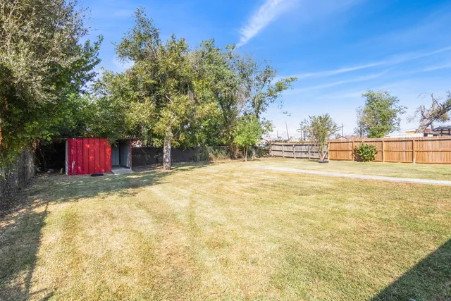 a view of yard with swimming pool and green space