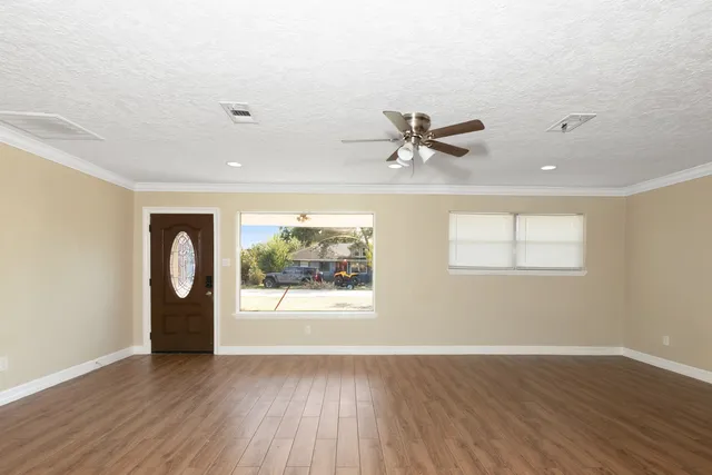 wooden floor in an empty room with a window