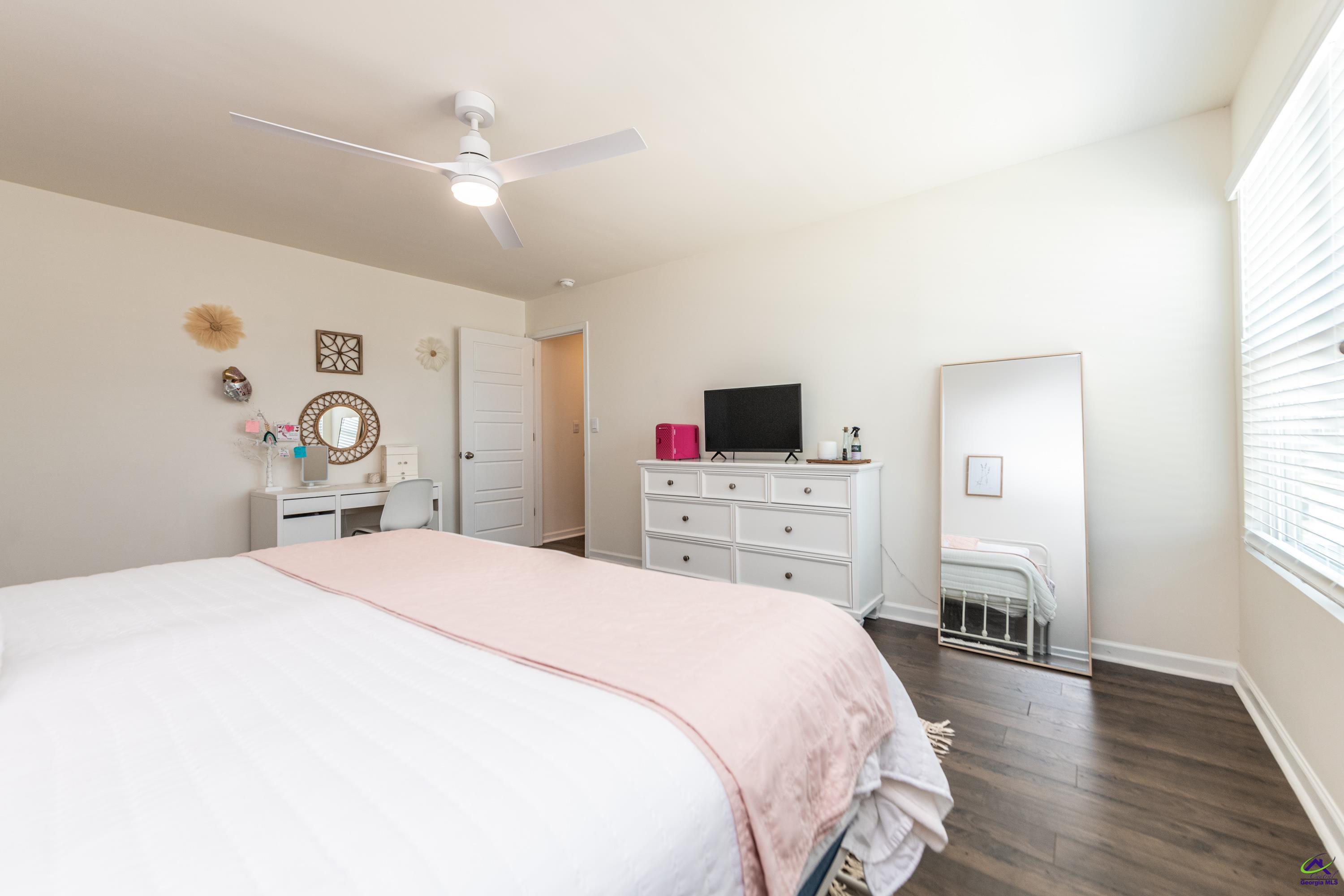 126 Farmers Way Perry, GA 31069 - Photo 33 of 39 a bedroom with a bed and a flat tv screen on the dresser