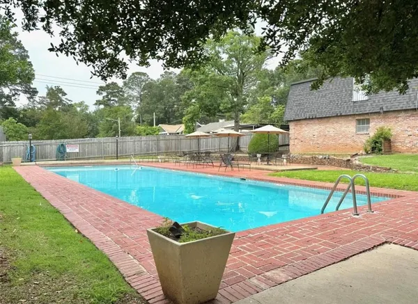 a view of a swimming pool with a yard