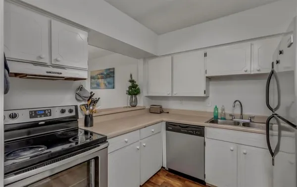 a kitchen with a sink appliances and cabinets
