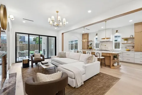 a living room with furniture and a chandelier