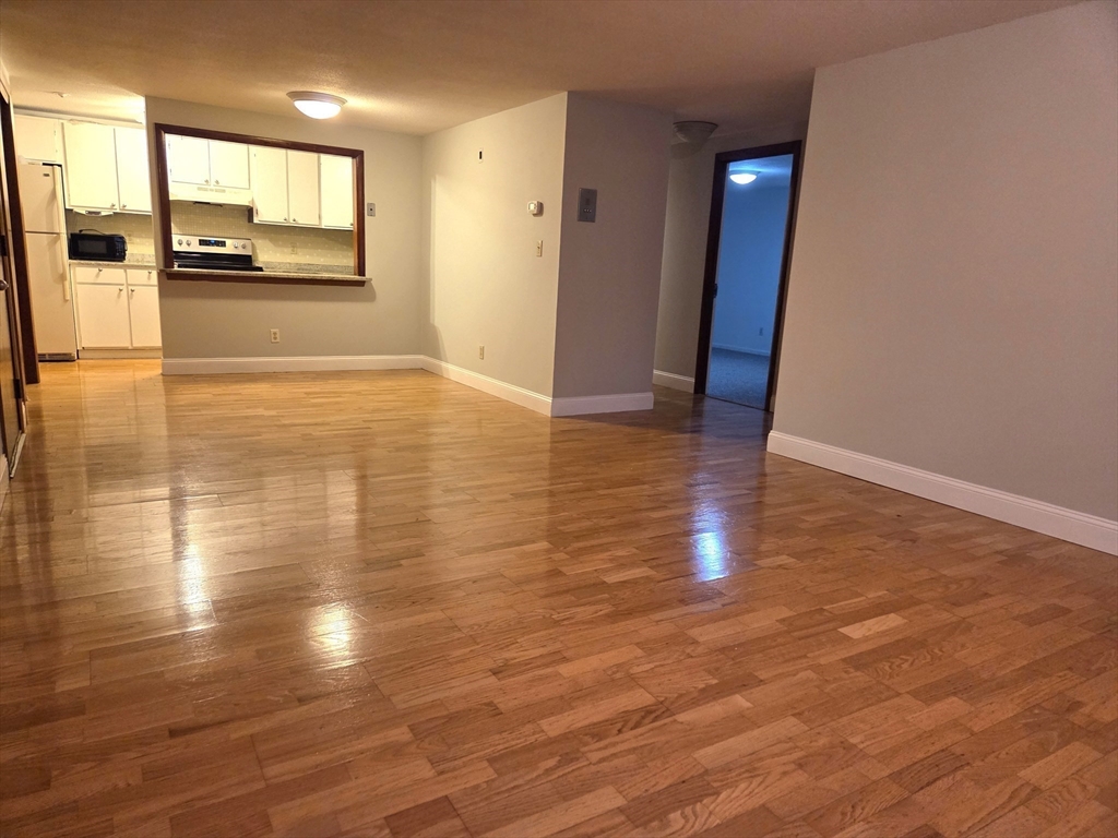 586 Boston Post Road East, Unit 6 Marlborough, MA 01752 - Photo 5 of 17 a view of a room with wooden floor and a window