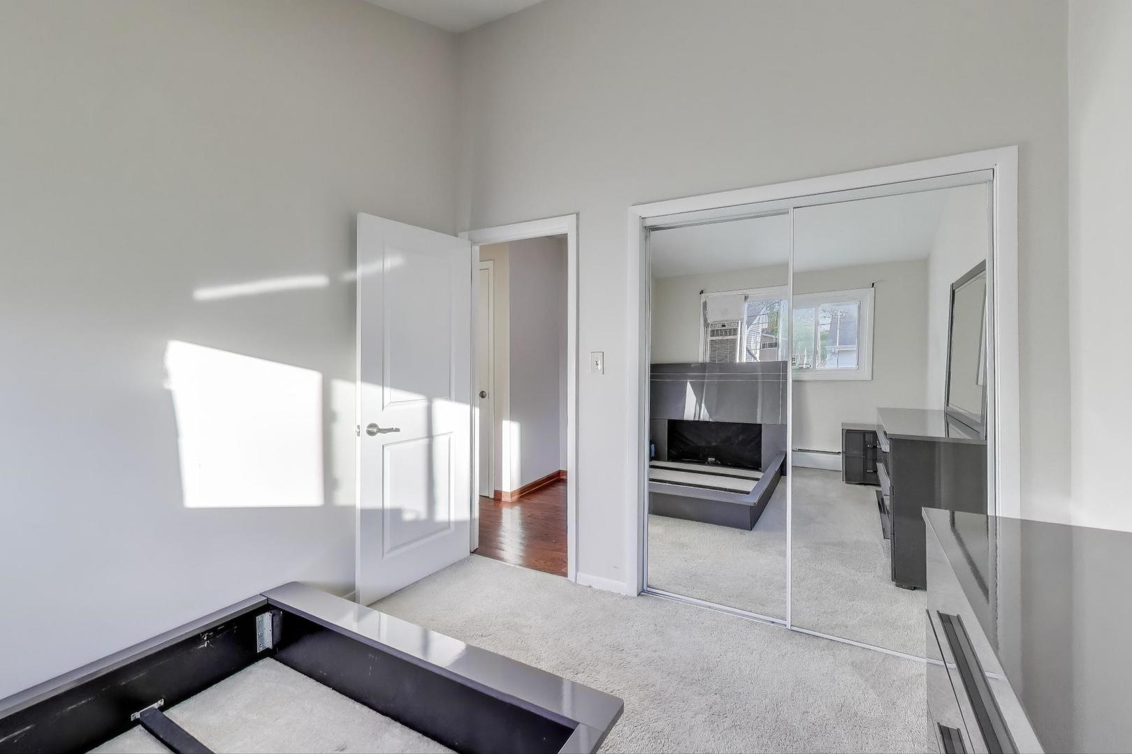 9454 Potter Road Des Plaines, IL 60016 - Photo 18 of 33 a living room with furniture and a table