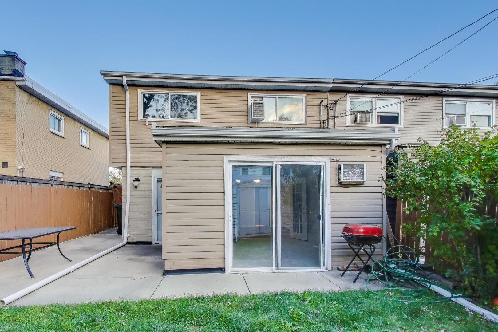 9454 Potter Road Des Plaines, IL 60016 - Photo 24 of 33 a view of a house with a backyard and a balcony