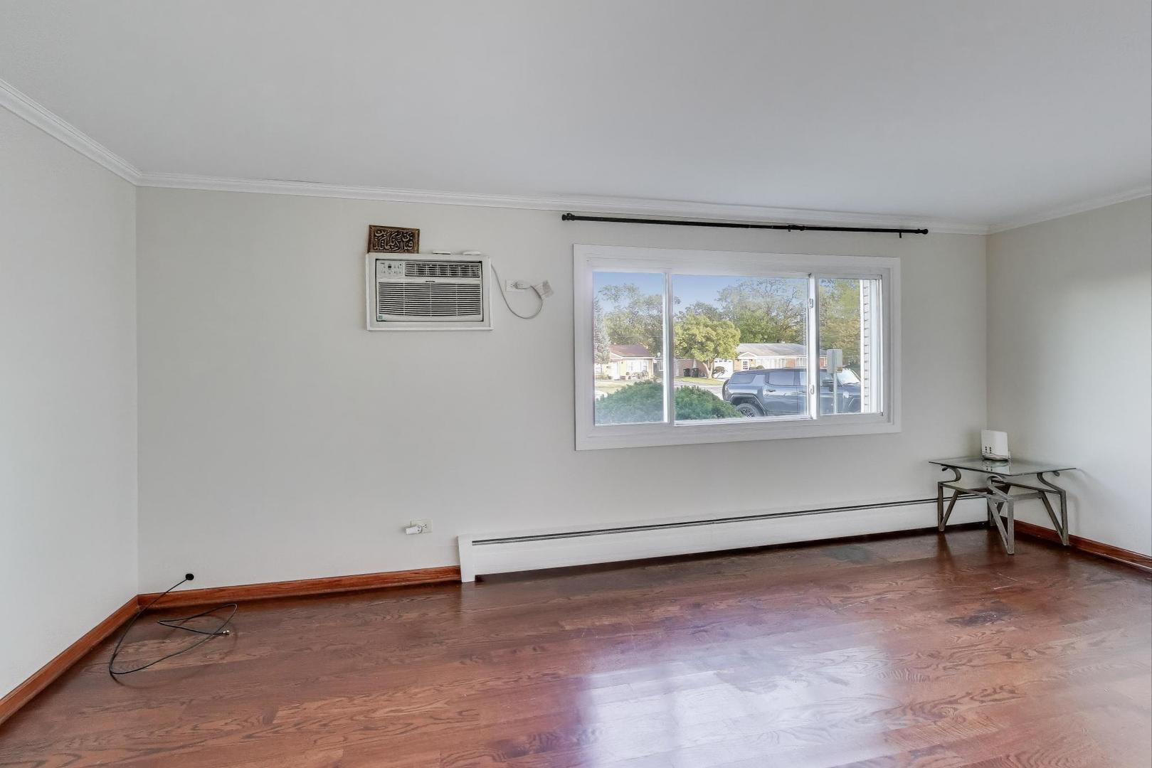 9454 Potter Road Des Plaines, IL 60016 - Photo 4 of 33 an empty room with a window