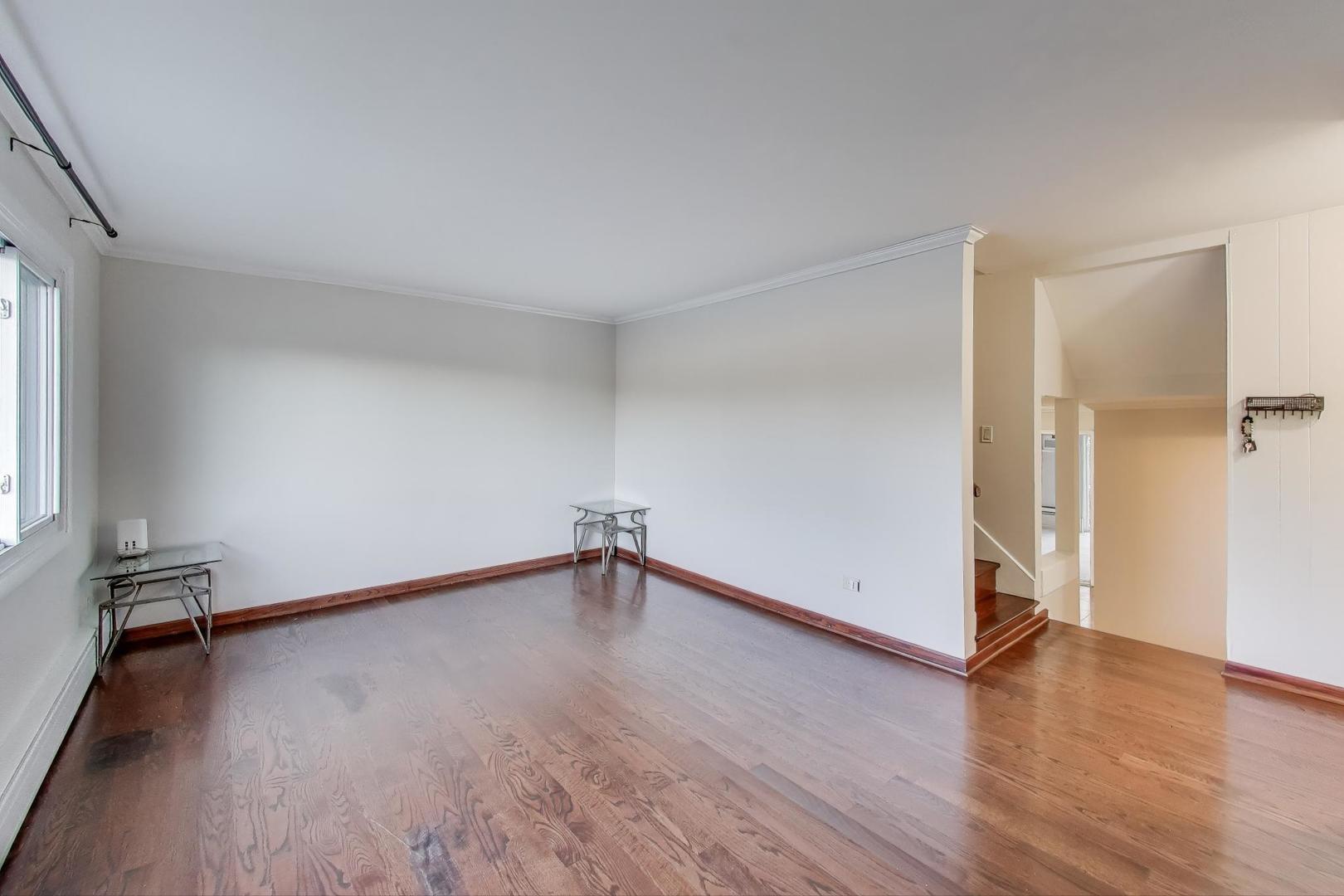 9454 Potter Road Des Plaines, IL 60016 - Photo 6 of 33 an empty room with wooden floor and a window