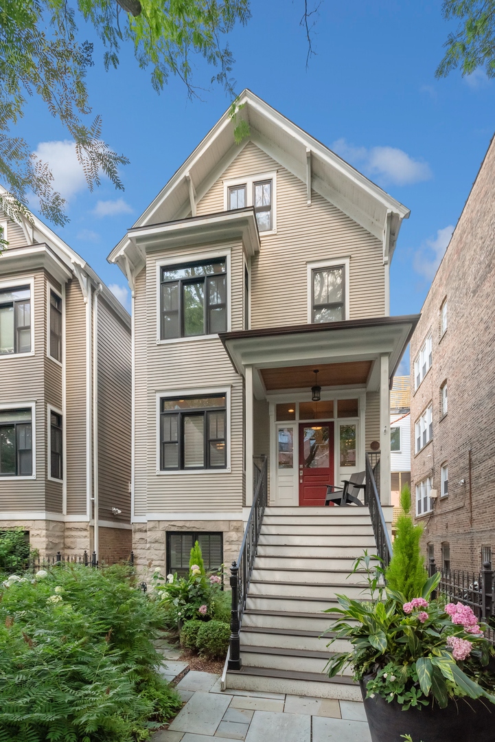 2413 North Orchard Street Chicago, IL 60614 - Photo 1 of 33 a view of a white house with large windows and a small yard