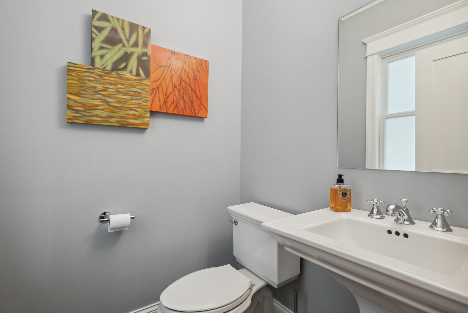 2413 North Orchard Street Chicago, IL 60614 - Photo 17 of 33 a bathroom with a toilet sink and mirror