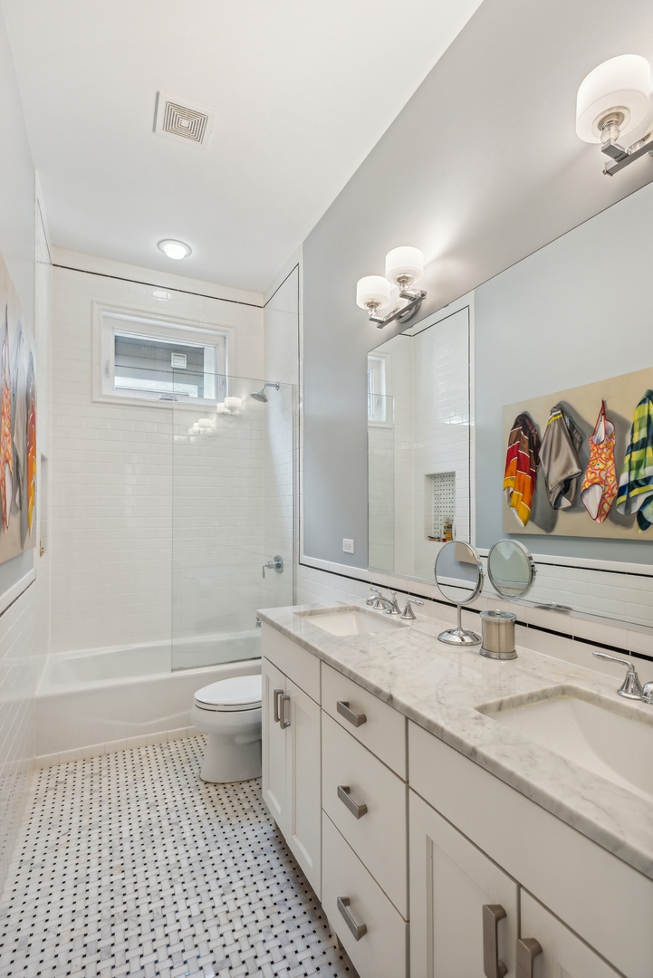 2413 North Orchard Street Chicago, IL 60614 - Photo 22 of 33 a bathroom with a sink a toilet and shower
