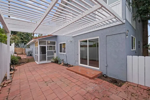 a view of a house with backyard porch and sitting area