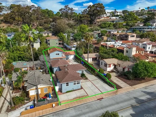 an aerial view of residential houses with outdoor space