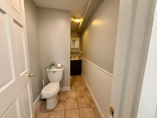 a bedroom with a bed and a potted plant