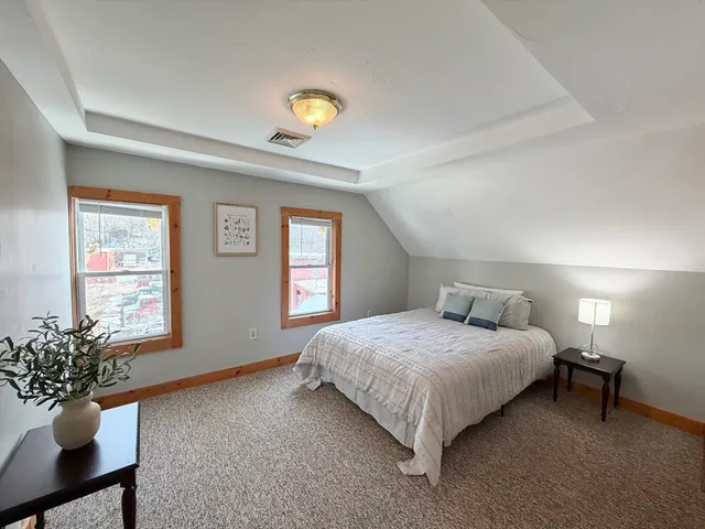 a backyard of a house with barbeque oven and covered with trees