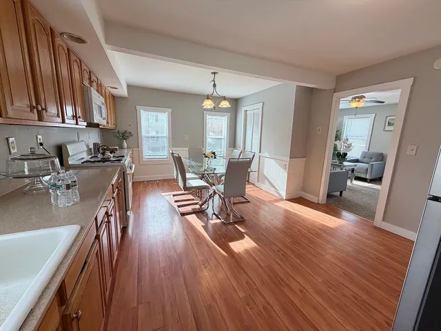 a view of a dining room with furniture and wooden floor