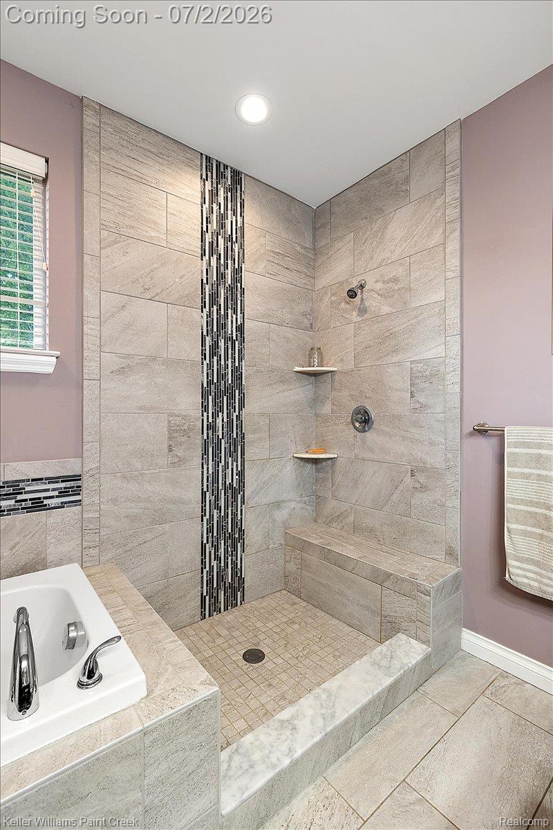 54230 Card Road Macomb, MI 48042 - Photo 53 of 73 Walk-in shower with full tile surround, integrated bench, and mosaic tile accent