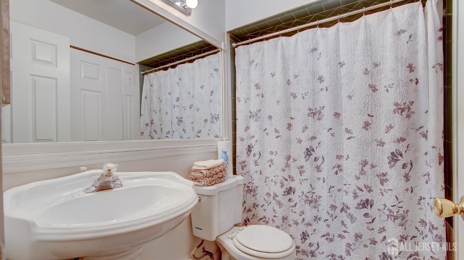 86 Arrowood Road, Unit G Manalapan, NJ 07726 - Photo 10 of 16 a bathroom with a toilet and a sink