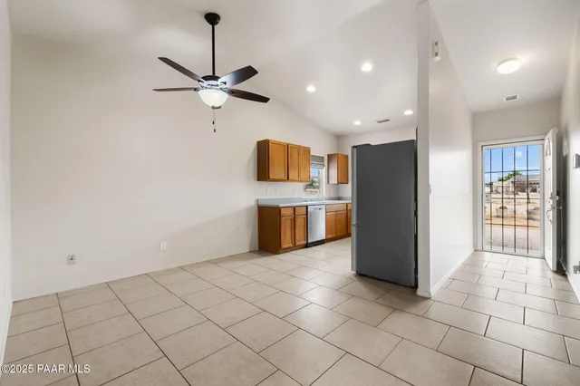 a kitchen with stainless steel appliances a refrigerator and a stove top oven