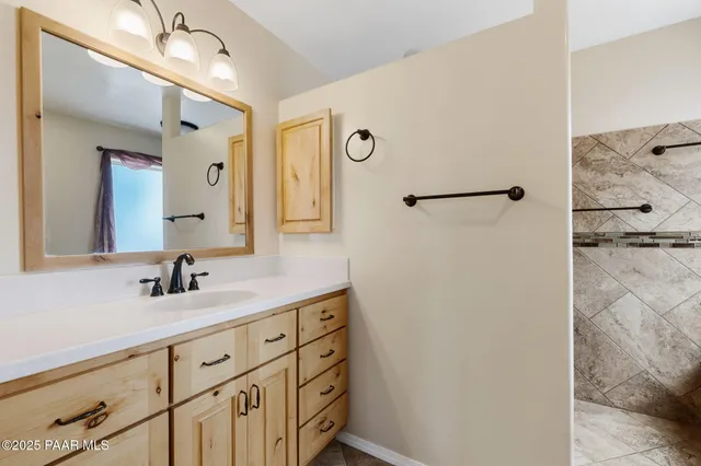 a bathroom with a double vanity sink and mirror