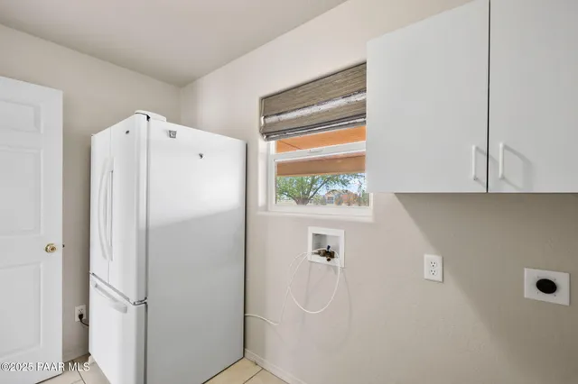 a white refrigerator freezer sitting in a kitchen