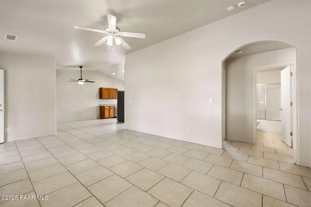 a view of a livingroom with a chandelier fan and a bathroom