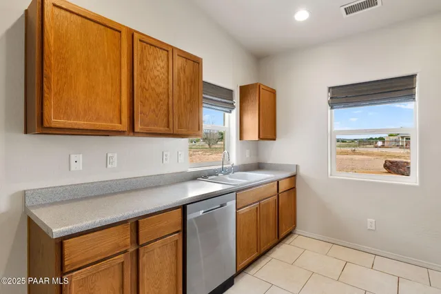 a kitchen with stainless steel appliances granite countertop a sink and a cabinets