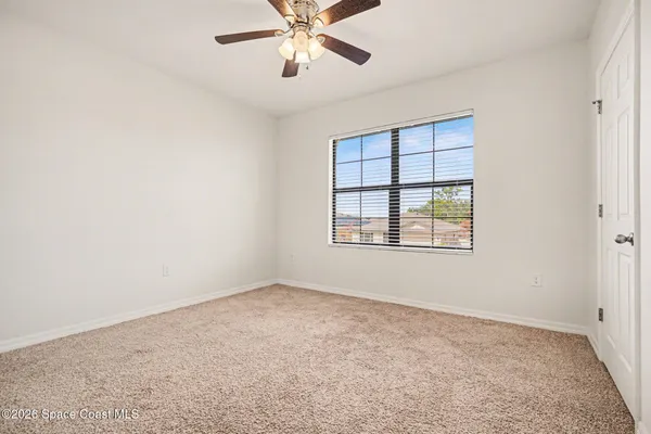 a view of room with a ceiling fan and hardwood floor