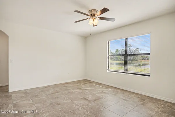 a view of kitchen with kitchen island white cabinets and stainless steel appliances