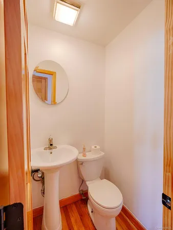 a white toilet sitting next to a bathroom sink